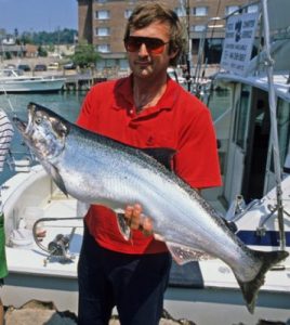 Angler holding a Lake Michigan coho salmon (PCB)