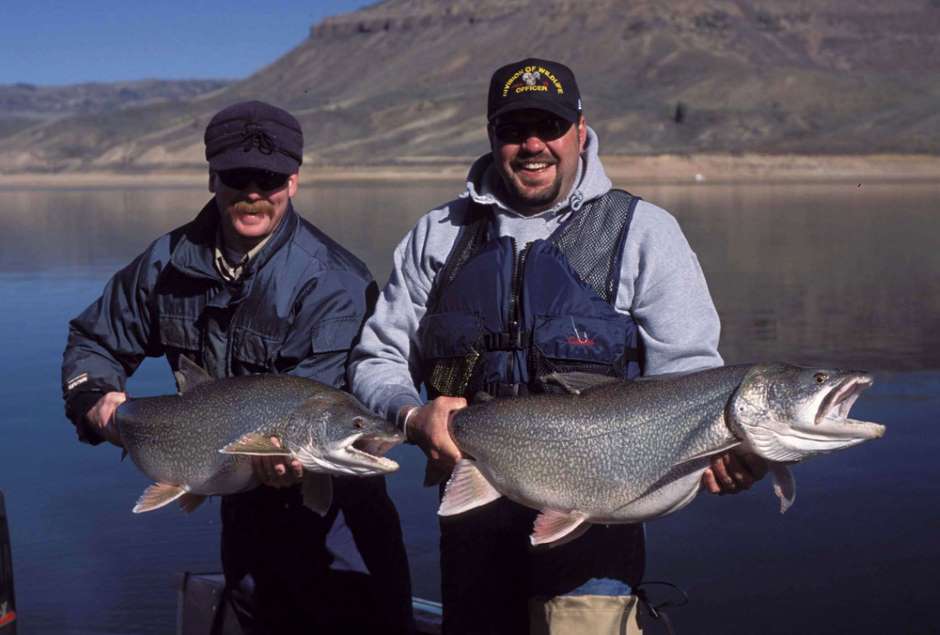 Division of Wildlife employees Matt Thorpe and Bob Carochi with lake trout caught on Blue Mesa Reservoir (Credit: Kevin Rogers/Colorado Parks and Wildlife)