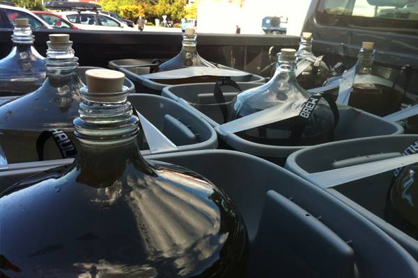 Highway runoff collected for the experiment was transported in glass carboys. (Credit: Jenifer McIntyre)
